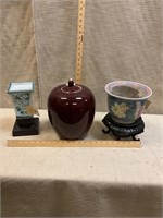 Lidded jar and ceramic vases on bases