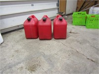 3 empty gas cans