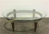 Oval glass top coffee table. 18 inches tall, 48