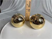 round golden colored candle holders