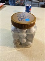 Plastic jar of 20 golf balls.