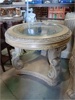 Circular ornate distressed end table with glass