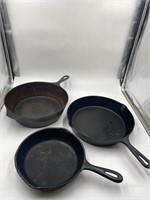 cast iron pans, one marked 8