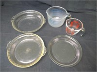 3 glass pie pans, and 2 glass measuring cups