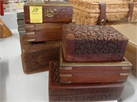 Six carved wooden boxes.
