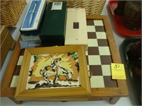 Chessboard, two Indian plaques, and writing pens.