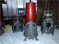 Three male decorative candle holders