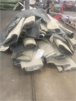 Various sizes of rolled grey indoor carpet