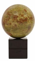 GEOLOGICAL GREEN MARBLE SPHERE ON GRANITE BASE