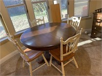 Wooden table and 4 chairs. 48 inches across. Has