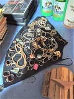 Group of costume jewelry on black fabric