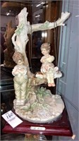 B. Merli boy w/ girl on swing figurine 11’’ tall