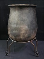 Vintage pottery vase on iron stand
