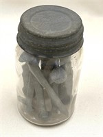 Vintage jar with nails