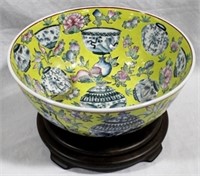 Oriental decorative bowl on wood stand