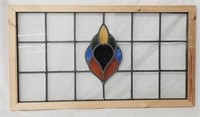 Stained glass window in wood frame