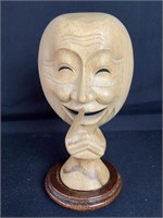 Carved wood, smiling face with base