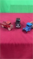 3 antique cast iron trucks and a cast iron trolley