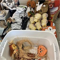 tote of Halloween decorations and horse mask