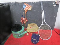 Hat, hat box, flags, tennis racquet.