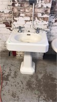 Old porcelain sink  has hot and cold faucet and