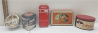 A collection of five Coca-Cola tins