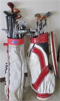 2 golf bags with clubs