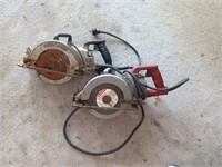 Two electric worm saws work