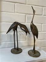 Two brass figurines. The tallest one is
