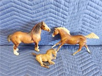 Three plastic horse figurines