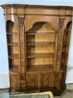 Impressive curved bookcase adorned flamed cherry