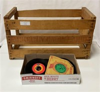 Approximately 50, 45 RPM records in wooden fruit