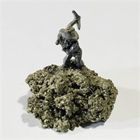Small Miner Figurine On Mineral