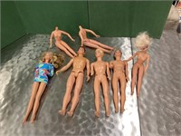 Collection of Ken and Barbie Dolls some extra clot