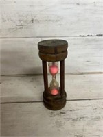 Small glass pink sand timer