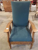 Antique green upholstered chair on wheels