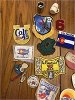 An assortment of patches and pins and wooden box