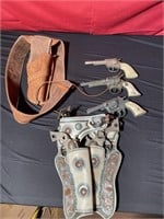 Toy cat pistols, and holsters some are damaged