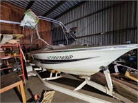 19' boat with inboard motor and trailer.