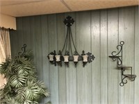 Grouping of metal wall sconces and a faux plants
