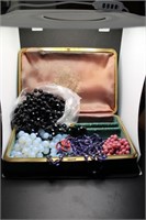 A Green Jewelry Box With Four Beaded Necklaces