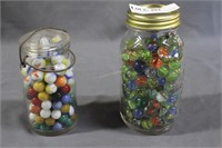 Two mason jars full of marbles - unsorted
