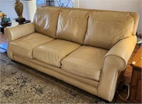 Lane Cream colored leather couch sits comfy