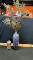 Shell vase and peacock feathers