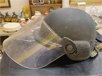 Metal riot helmet marked Unicor with face