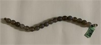 Gray beads over sterling silver bracelet