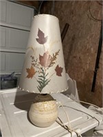 Pottery lamp with leaf shade.