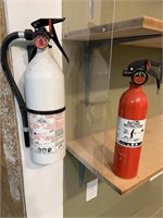 Pair of fire extinguishers, together.