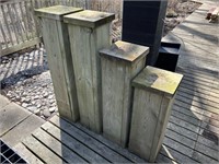 Four wooden garden pedestals.