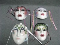 Four Glazed Ceramic Masks With Ribbons